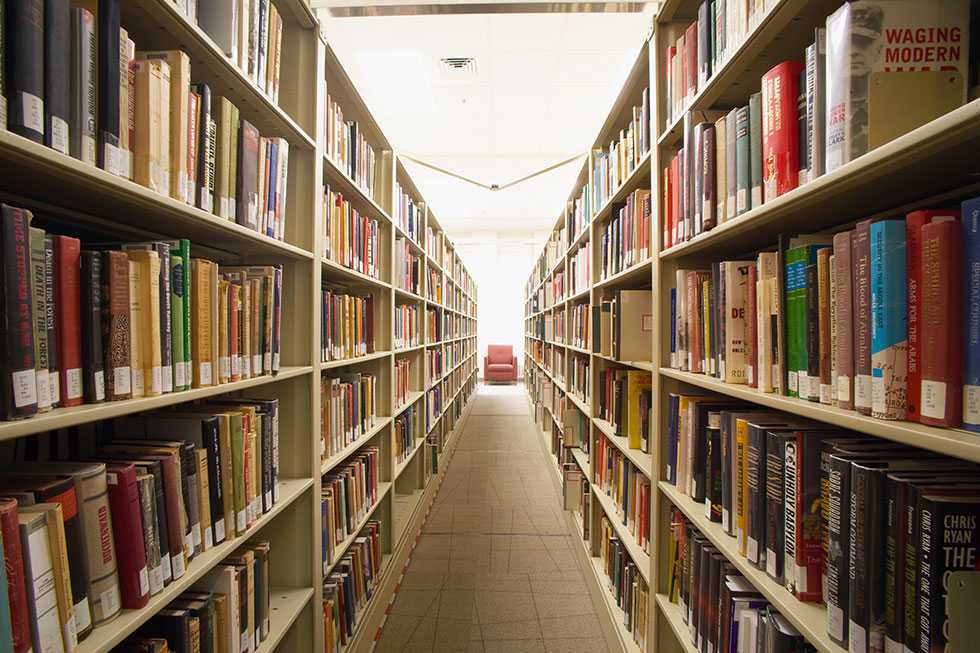 Two rows of full bookshelves opposite each other.